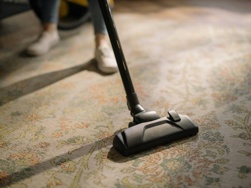 How do you clean rugs and remove stains?